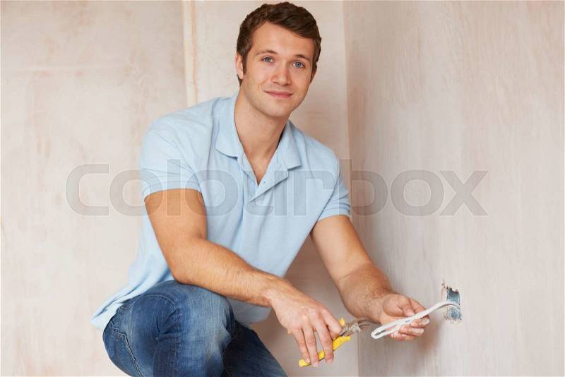 Electrician Installing Socket In New House, stock photo