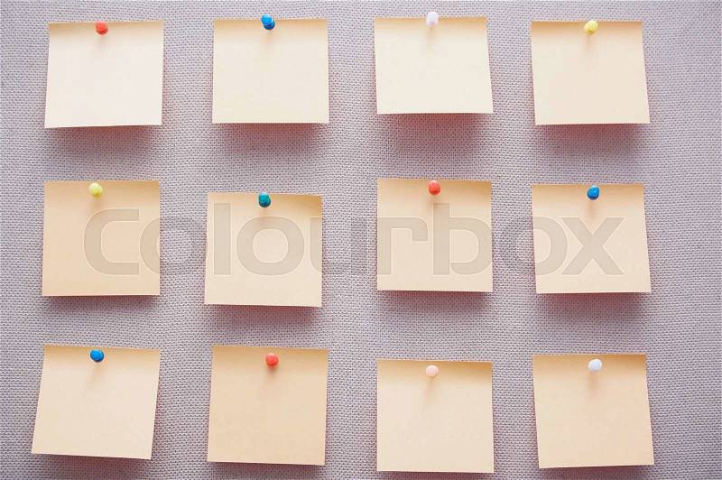 Sticky notes on a bulletin board. Close-up view, stock photo