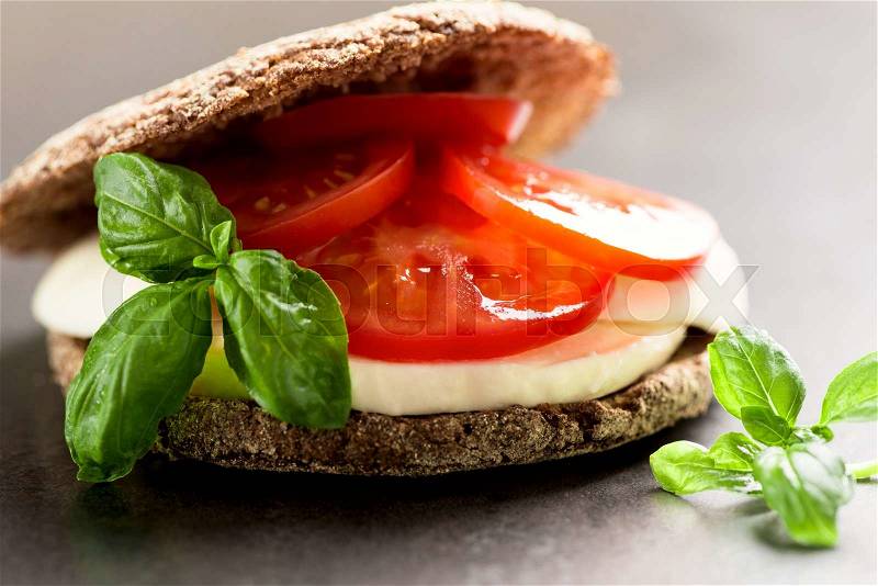Sandwich with mozzarella, tomatoes and rye bread, stock photo