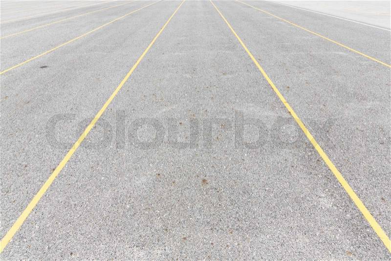 Concrete road texture with yellow color lines, outdoor parking lot, empty street, stock photo