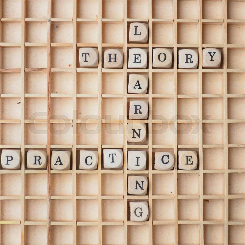 Learning concept with wooden dices and the words theory and practice, stock photo