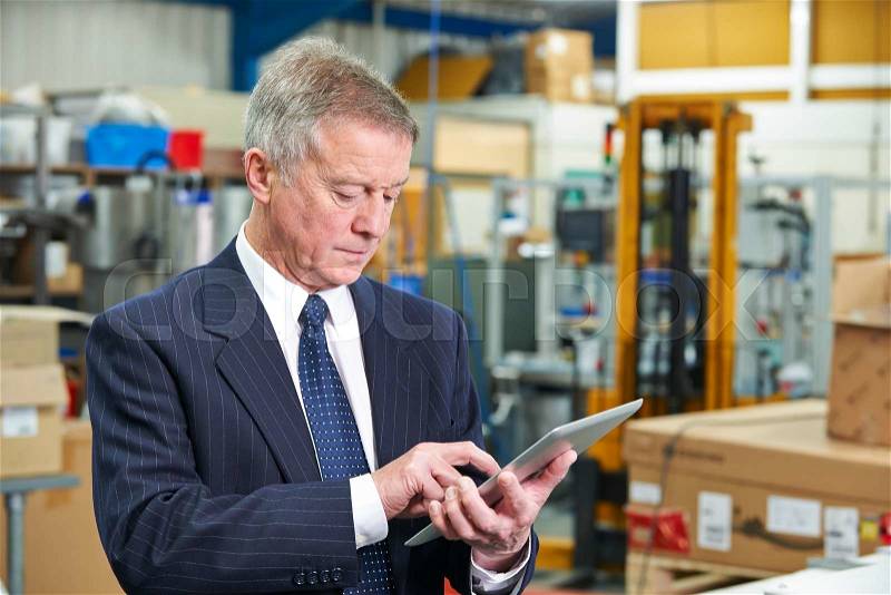 Factory Owner Using Digital Tablet , stock photo