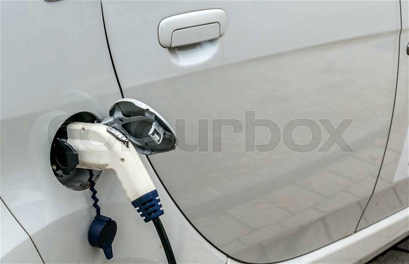 Electric car at charging station. symbol of ecology, environmental protection, innovation, stock photo