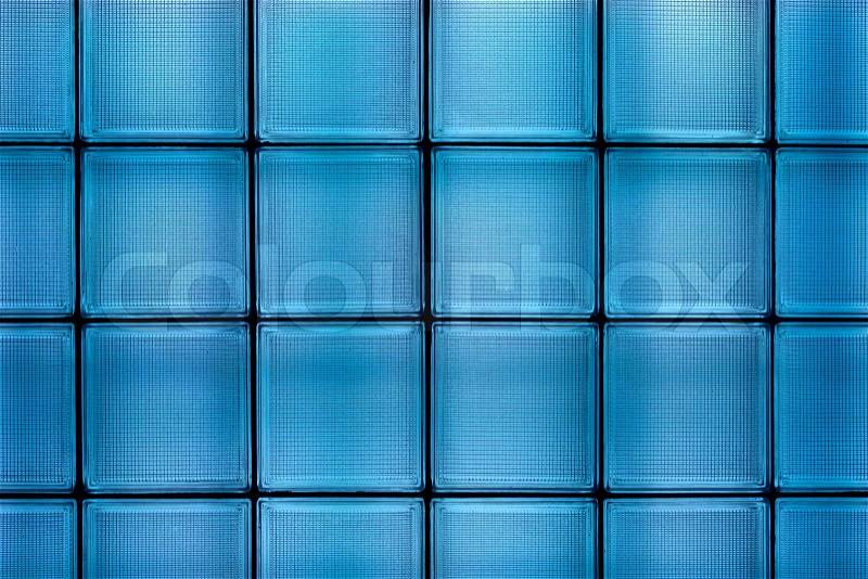 Clean blue transparent textured square glass tile wall construction, stock photo