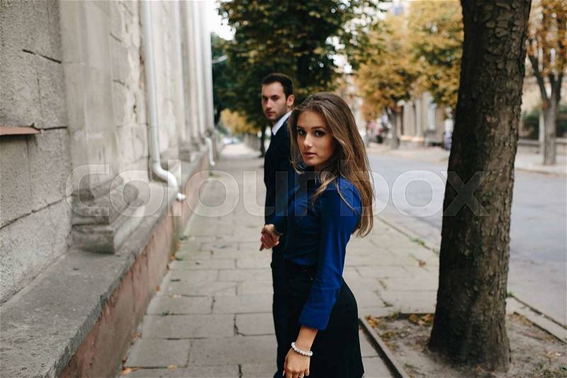 Man and woman walking together on the street, stock photo