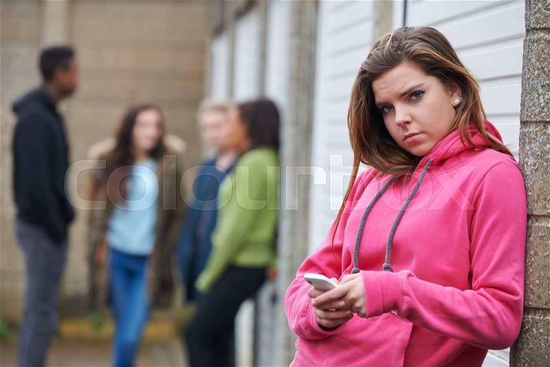 Teenage Girl Using Mobile Phone In Urban Setting, stock photo