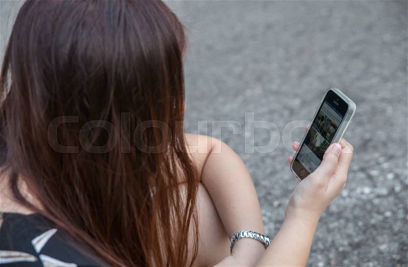 Woman Using a Smart Phone at road, stock photo