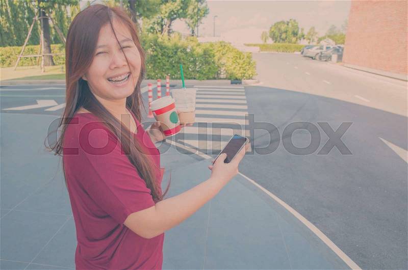 Woman Using a Smart Phone. Vintage filter, stock photo