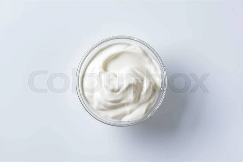 Bowl of sour cream on white background, stock photo
