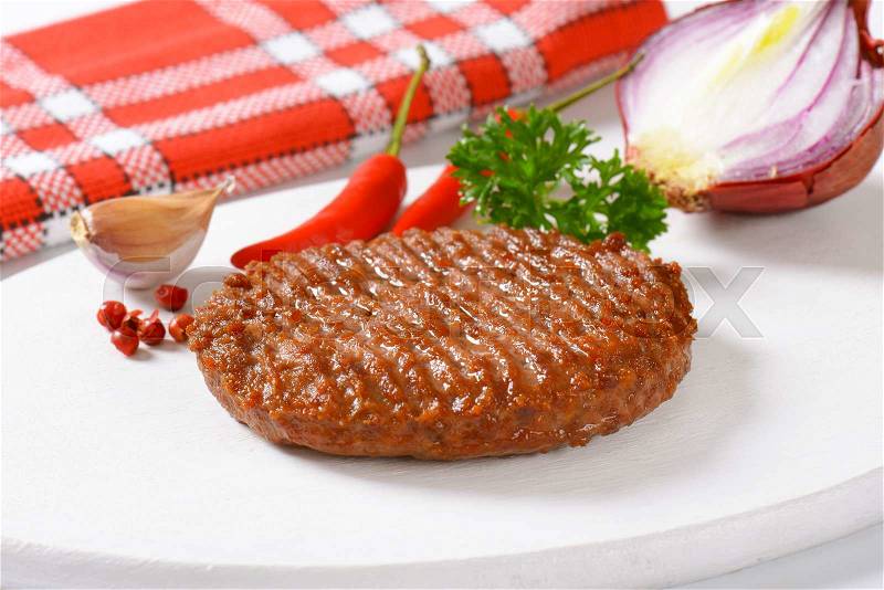 Grilled Beef Burger Patty on cutting board, stock photo