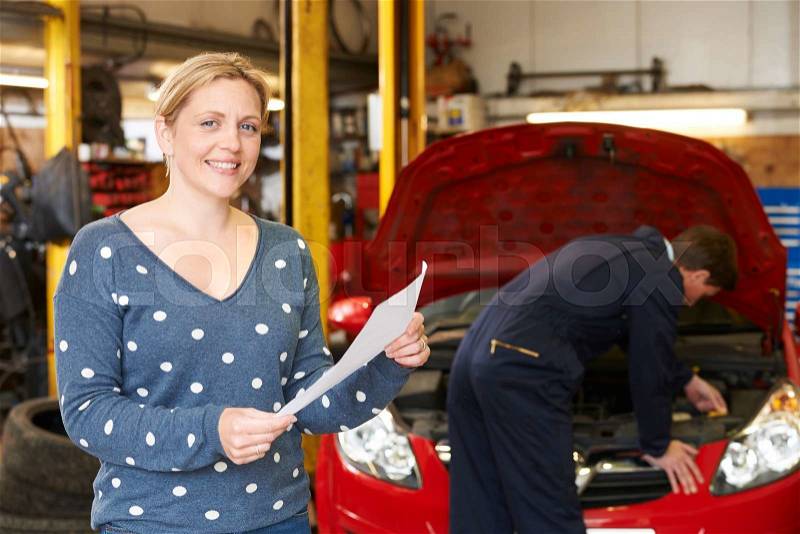 Happy Woman With Garage Repair Bill, stock photo