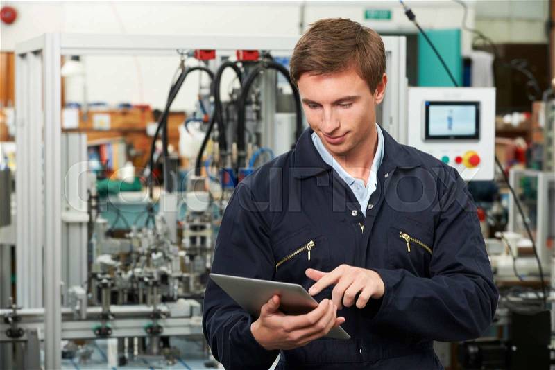 Engineer In Factory Using Digital Tablet, stock photo