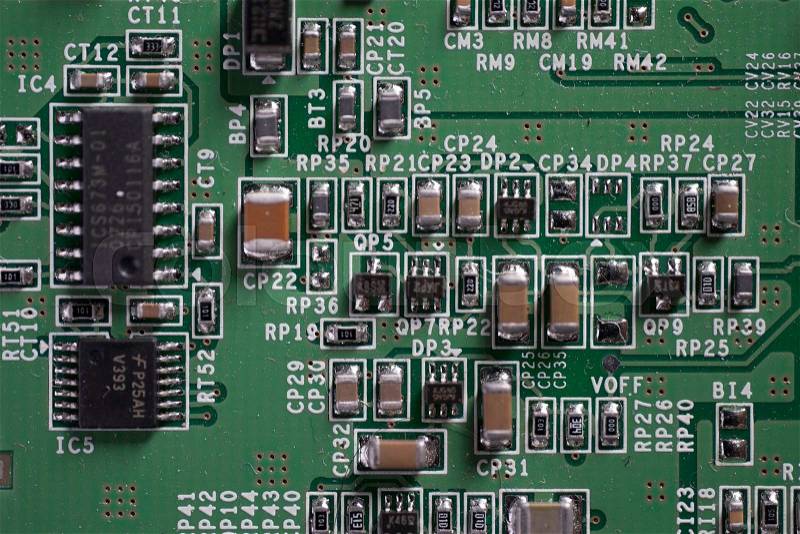 Detail of an electronic printed circuit board with many electrical components, stock photo