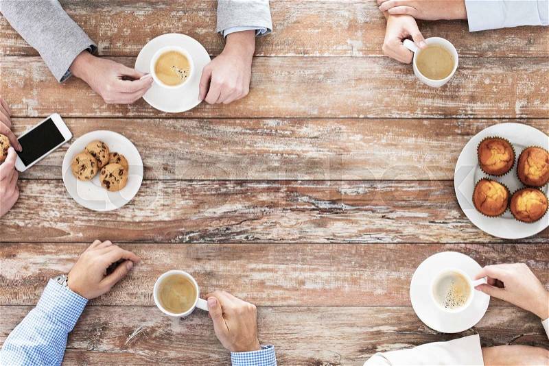 Business, people and team work concept - close up of creative team meeting and drinking coffee during lunch in office, stock photo
