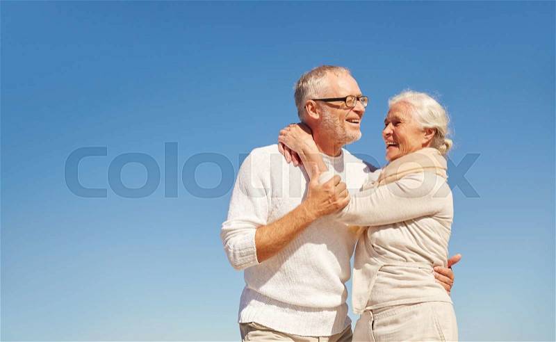 Family, love and people concept - happy senior couple hugging outdoors, stock photo