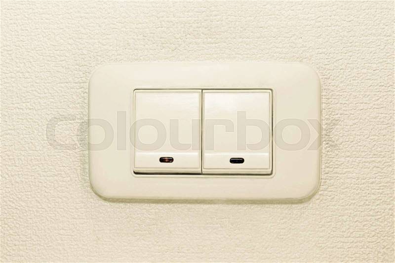Light switch on beige wall background taken closeup, stock photo