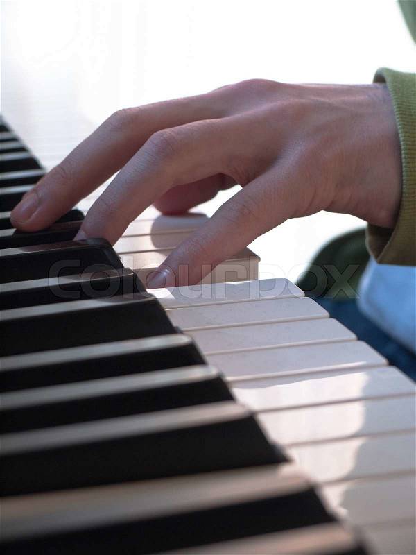 Close-up of man playing piano, stock photo