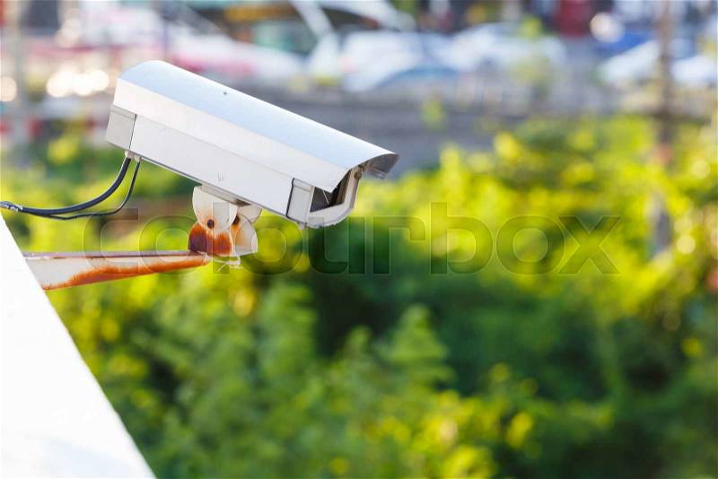 CCTV surveillance camera on top of building , stock photo