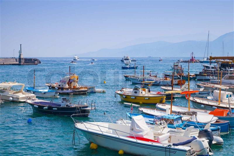 Moored pleasure motorboats in port of Capri island, Italy, stock photo