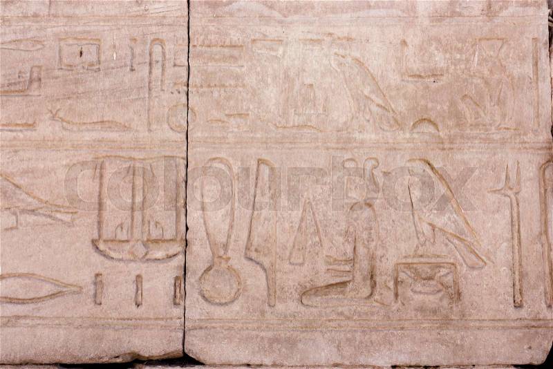 Egyptian hieroglyphs. Hieroglyphic carvings on a wall, stock photo
