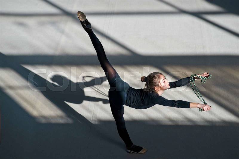 Girl making balance rope. rhythmic gymnastics, stock photo
