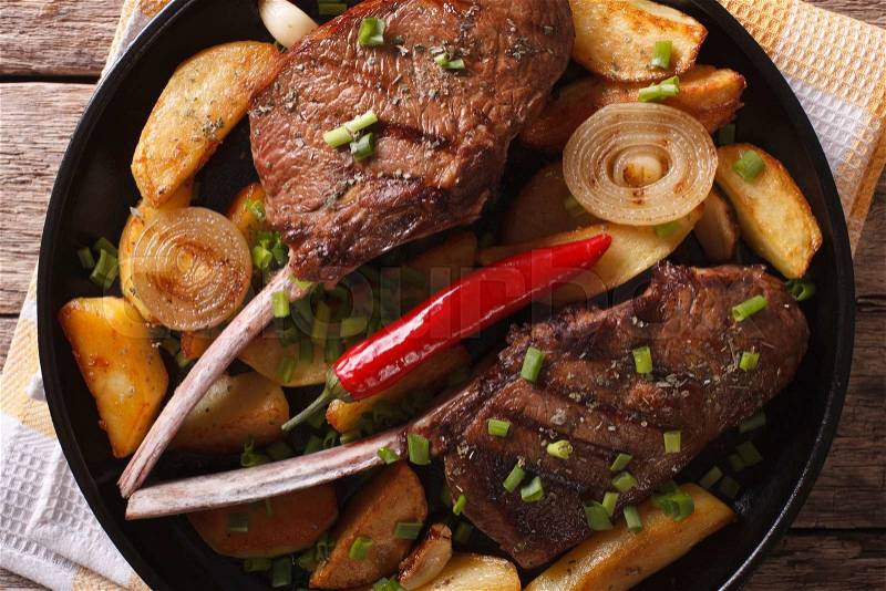 Grilled beef steak and fried potatoes close up on a plate on the table. horizontal top view , stock photo
