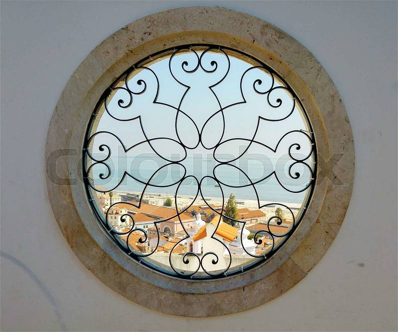 Round art window with view on the harbor and old city of lissabon in Portugal, stock photo