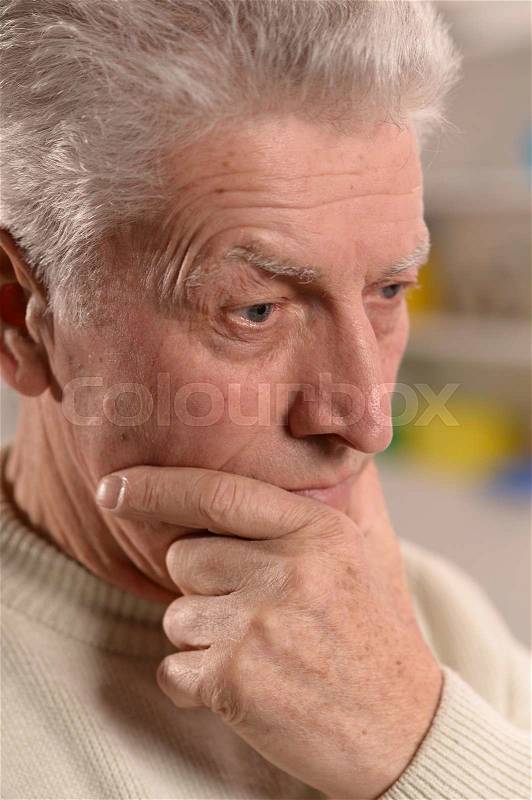 Portrait of a thoughtful smiling elder man close-up , stock photo