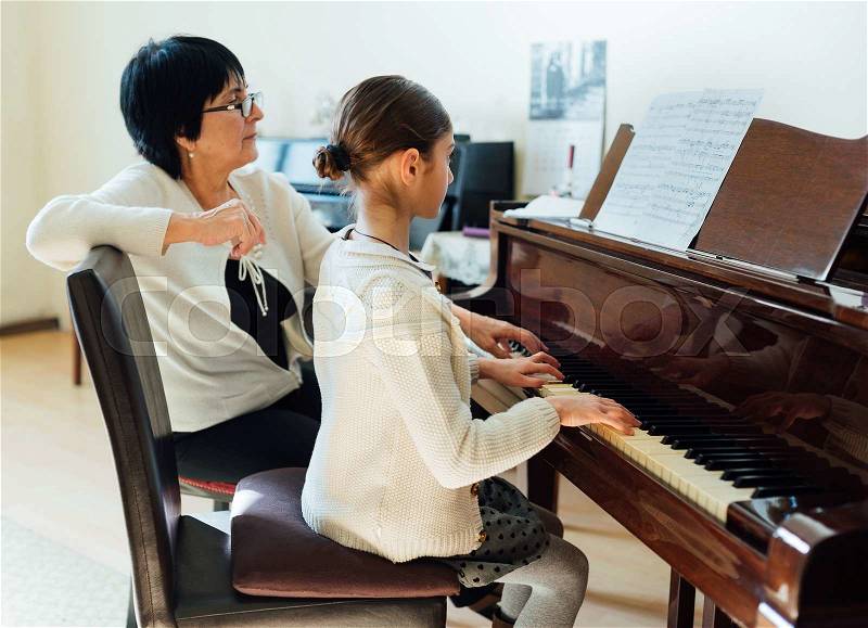 Piano lessons at a music school, stock photo
