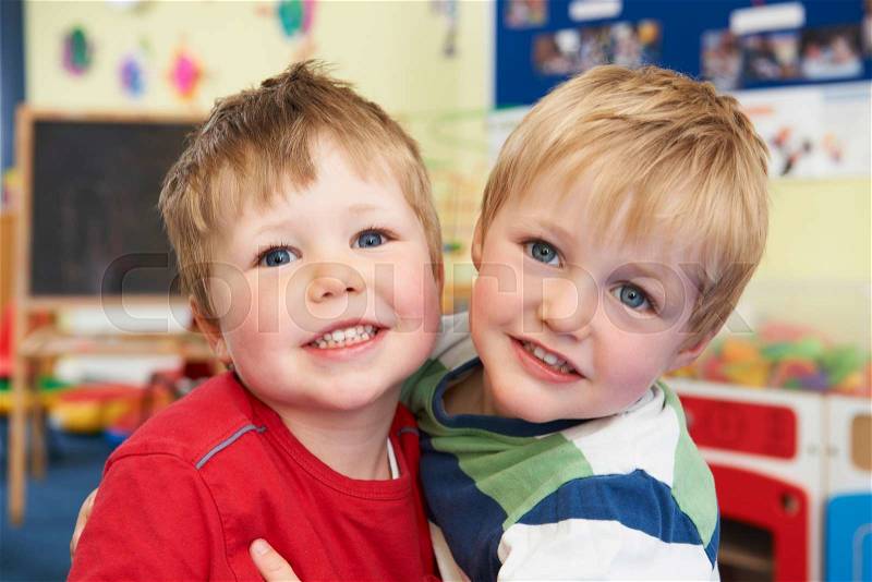 Two Boys Hugging One Another At Pre School, stock photo