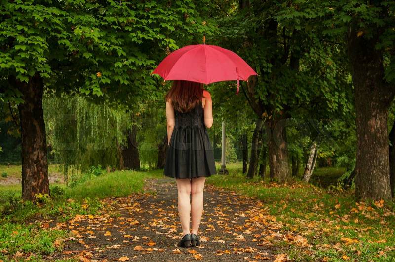 Girl in a black dress with umbrella, stock photo
