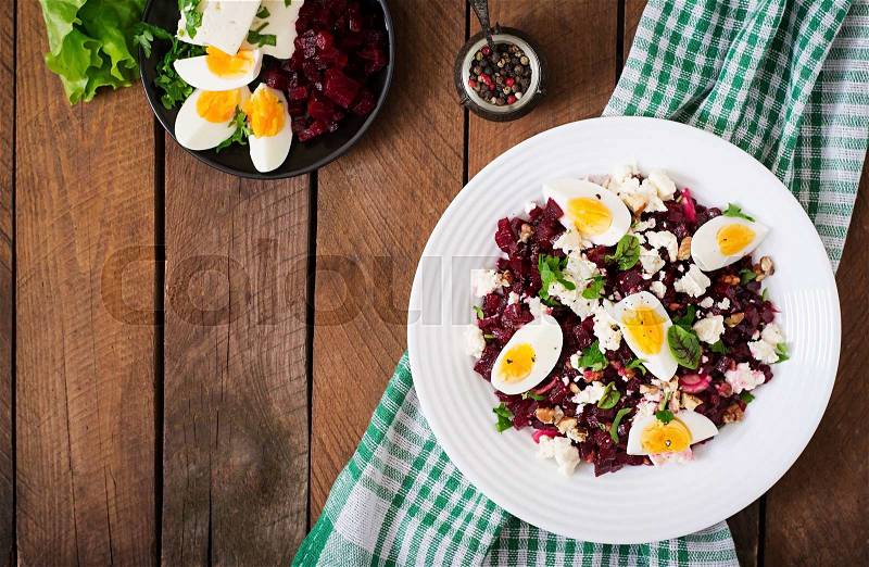 Salad baked beets, feta cheese, eggs, and walnuts. Top view, stock photo