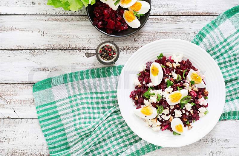 Salad baked beets, feta cheese, eggs, and walnuts. Top view, stock photo
