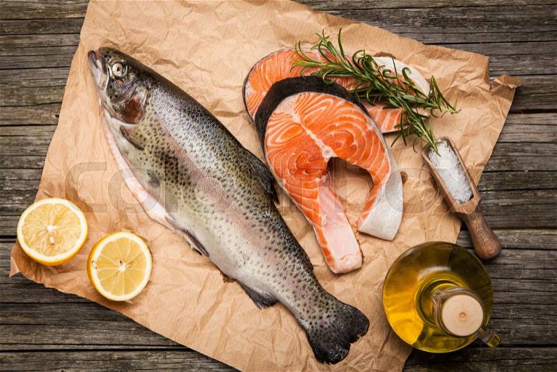 Fresh salmon slices and trout on old wood, stock photo