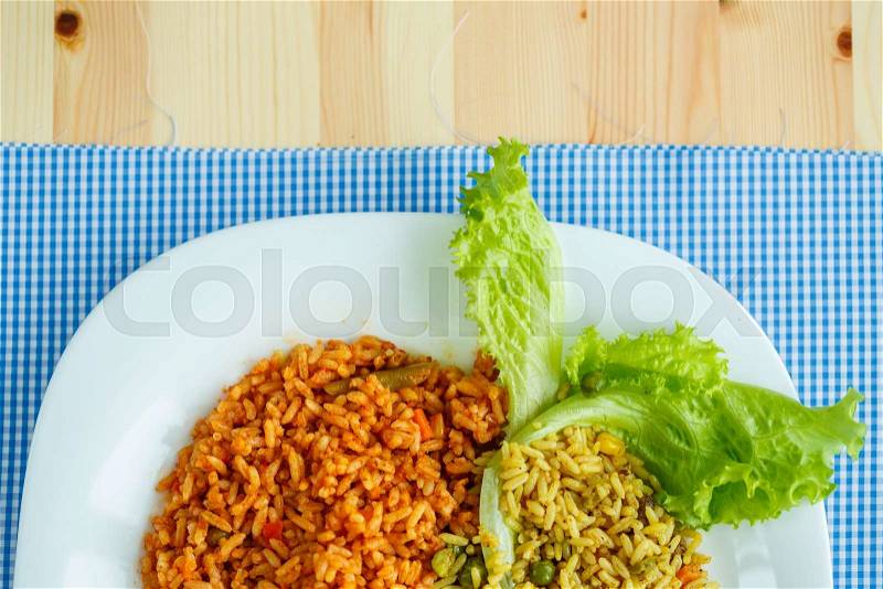 Delicious dish made of two kinds of rice on a white plate, stock photo