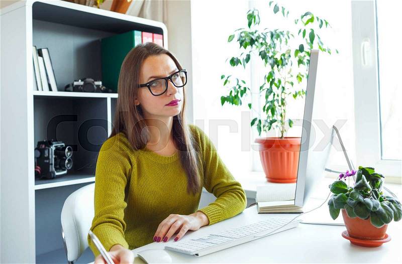 Beautiful young woman working from home - modern business concept, stock photo