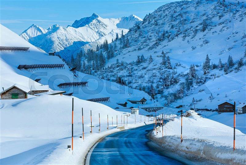 Winter mountain country road with snowy slope (Austria, Tyrol), stock photo