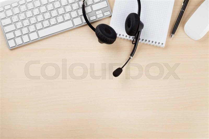 Office desk with headset and supplies. Call center table. Top veiw with copy space, stock photo