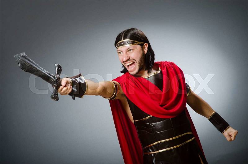 Roman warrior with sword against background, stock photo