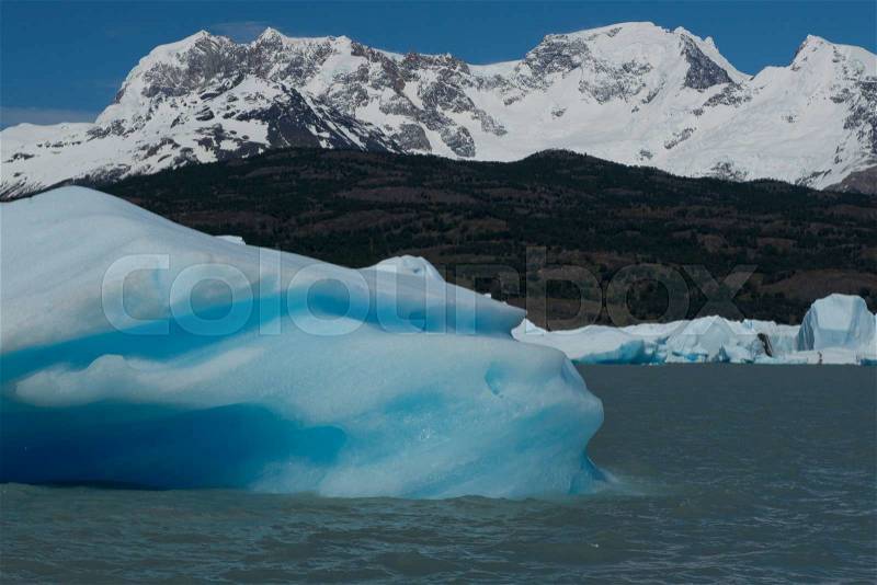 Spectacular blue iceberg floating on the Lake Argentino in the Los Glaciares National Park, Patagonia, Argentina, stock photo