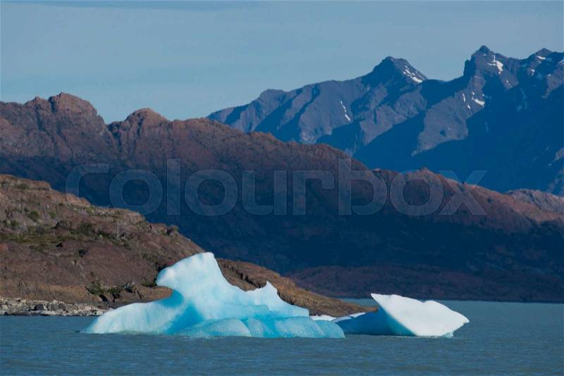 Spectacular blue iceberg floating on the Lake Argentino in the Los Glaciares National Park, Patagonia, Argentina, stock photo