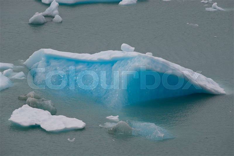 Spectacular blue icebergs floating on the Lake Argentino in the Los Glaciares National Park, Patagonia, Argentina, stock photo