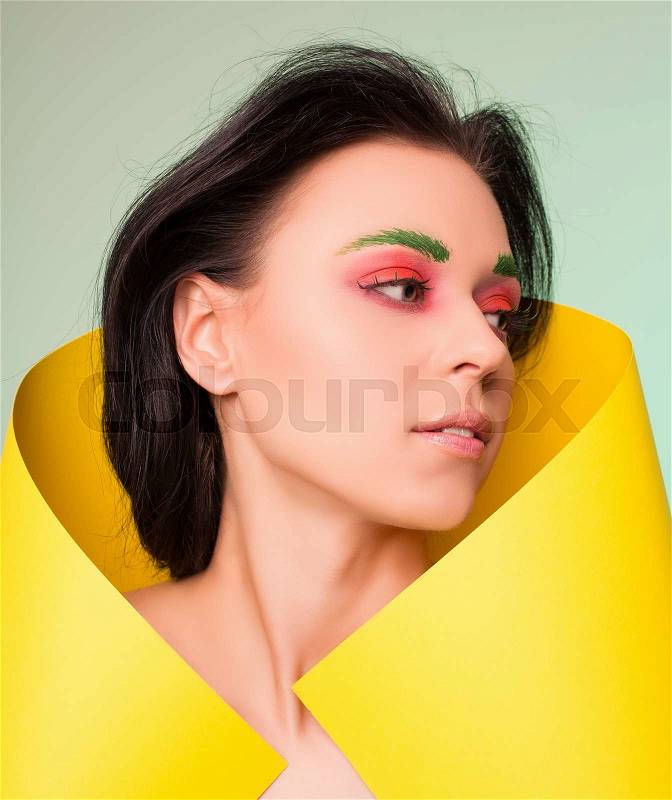Creative approach to the photograph. model in yellow paper, stock photo