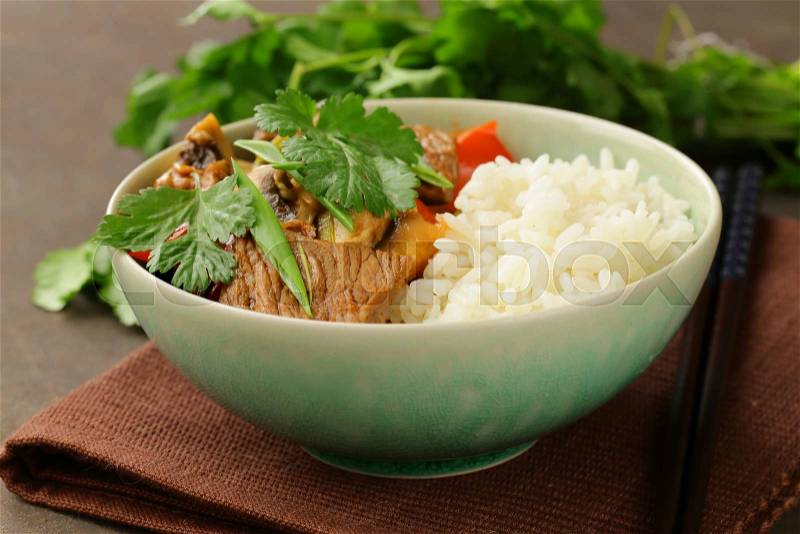 Traditional Asian food - white rice and meat with vegetables in soy sauce, stock photo