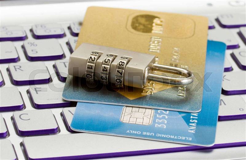 Internet transaction security concept - plastic cards with padlock on notebook keyboard, stock photo