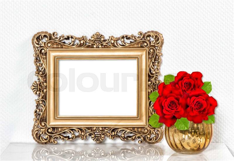 Golden picture frame and red roses flowers. Vintage style decoration with space for your picture or text, stock photo