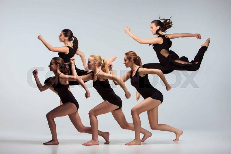 The group of modern ballet dancers dancing on gray background, stock photo