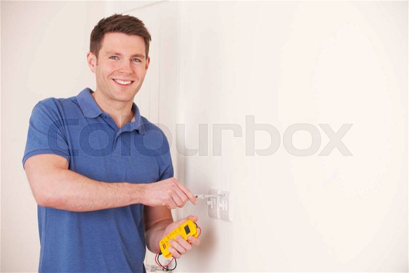 Electrician Checking Wiring On Electrical Switch, stock photo