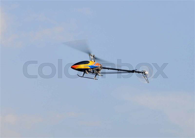 Flying remote controlled helicopter, stock photo