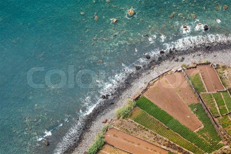 Amazing view from the highest Cabo Girao cliff on the beach, ocean water and Camara de Lobos town, Madeira island, Portugal, stock photo